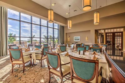 Elegant dining room with large windows and table settings