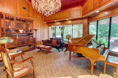 Elegant living room with a piano and chandelier