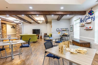 Bright interior activity area with tables and games