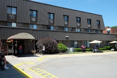 Exterior view of The Eliot Erie Station with residents outside
