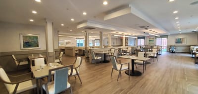 Bright dining room with tables and chairs set up