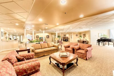 Bright common area with seating and piano