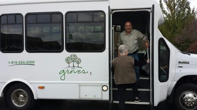 Residents boarding a transport van to the facility