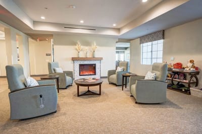 Interior view of a cozy common area with seating and fireplace