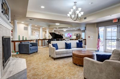 Bright common area with seating and piano