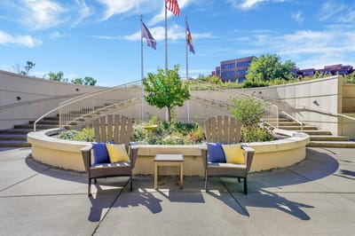Outdoor seating area with chairs and a garden