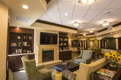 Bright common area with comfortable seating and fireplace
