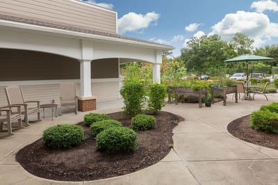 A landscaped outdoor space with seating and garden beds
