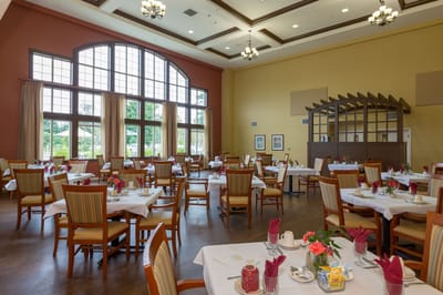 Dining room with neatly arranged tables and flowers