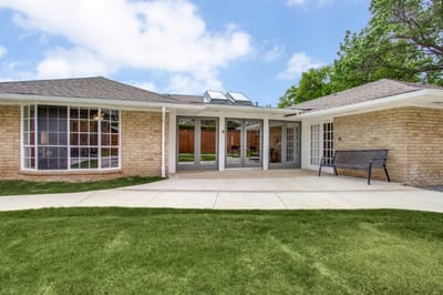 Exterior view of the facility's entrance and garden area