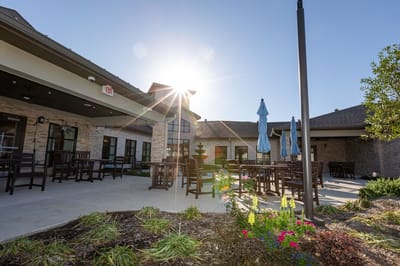 Outdoor seating area with umbrellas and landscaping