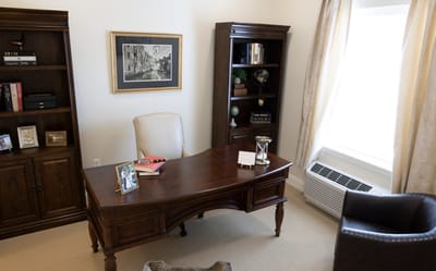 A well-furnished office space with a desk and bookshelf