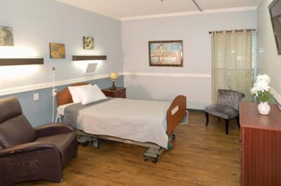A cozy private resident room with a bed and furniture