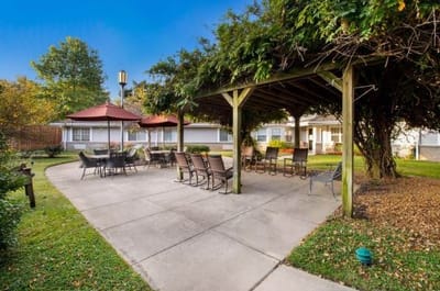 Covered outdoor seating area with tables and chairs