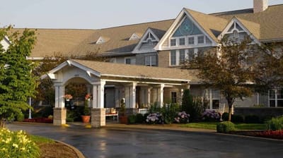 Exterior view of the assisted living facility with gardens