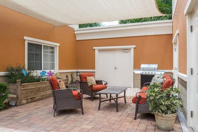 Outdoor seating area with plants and grill