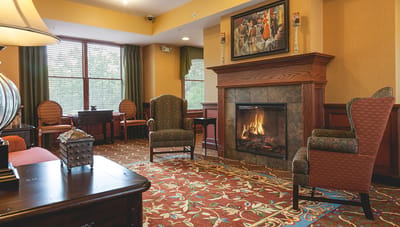 Cozy lounge area with seating and a fireplace