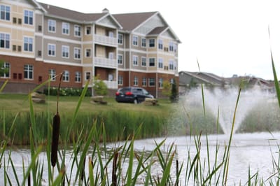 Exterior view of Wittenberg Village with landscaping and water feature
