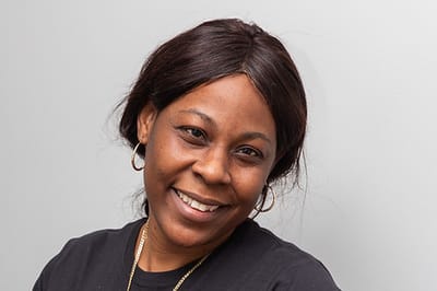 Staff member smiling at the camera.
