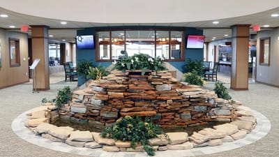 Indoor feature with rock fountain and greenery