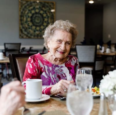 A resident enjoying a meal in the dining room