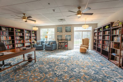 Interior of a bright library with bookshelves and seating