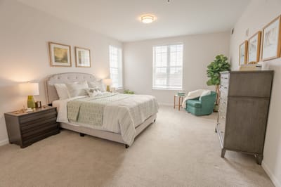 Bright, well-furnished bedroom in a senior living facility