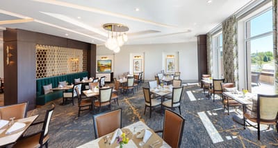 Bright dining room with elegant decor and tables set for meals