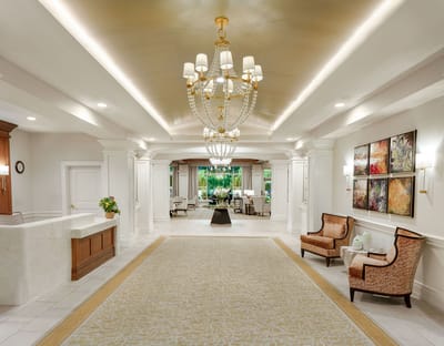Interior view of a stylish lobby with chandelier and seating