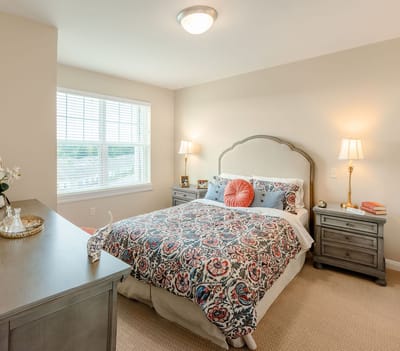 Comfortable private bedroom with a colorful bedspread