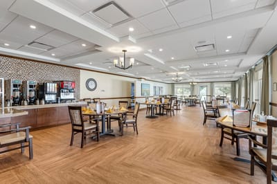 Bright and spacious dining room with tables set for meals