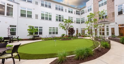 A serene courtyard with green landscaping and seating