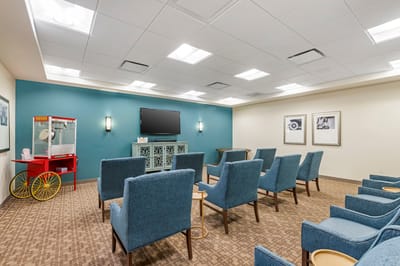 Common area with teal walls and blue chairs
