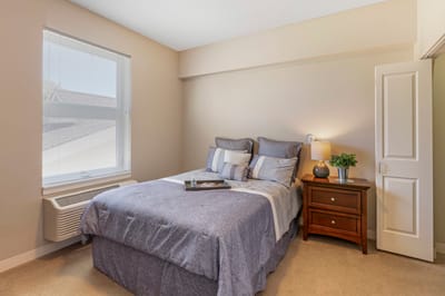 Cozy private resident room with a bed and nightstand