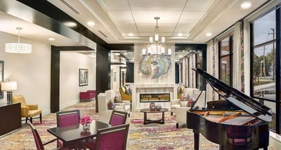 Welcoming common area with seating and a piano