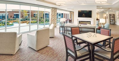 Interior view of a common area with outdoor garden visible