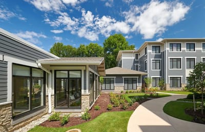 Exterior view of the assisted living facility with gardens