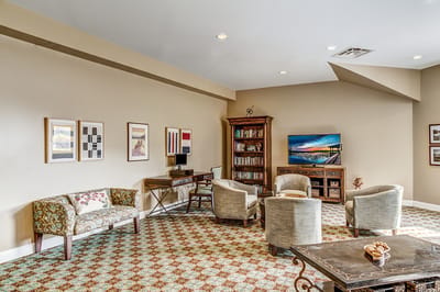 Interior view of a common area with seating and bookshelf