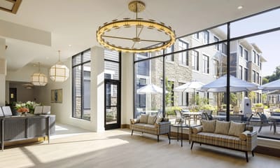 Bright and open common area with large windows and outdoor views