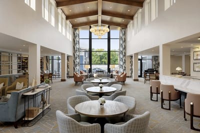 Bright common area with seating and large windows