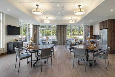 Bright common area with tables and art supplies