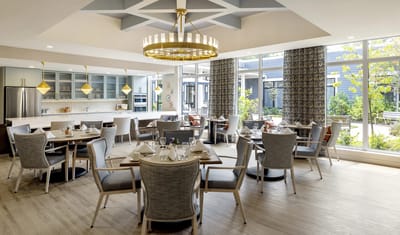 Bright and modern dining room with tables set for meals