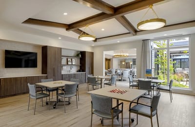 Bright interior activity room with tables and natural light
