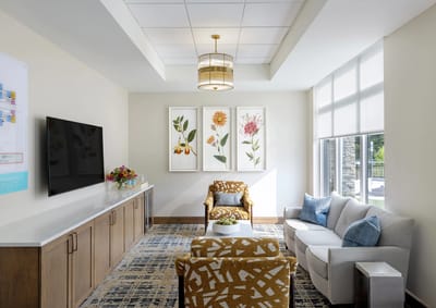 Bright common area with floral artwork and comfortable seating