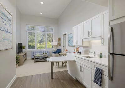 Modern kitchenette and living area in a resident unit