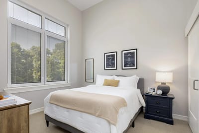 Brightly furnished resident room with large windows