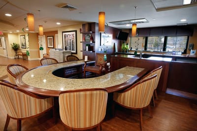 Interior view of a facility lounge area with a curved bar