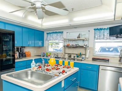Bright kitchen with fruit and drinks arranged on the counter