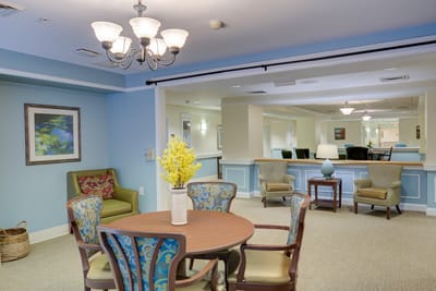 Common area with seating and decor in a senior living facility