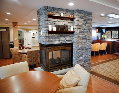 Cozy common area with a stone fireplace and seating